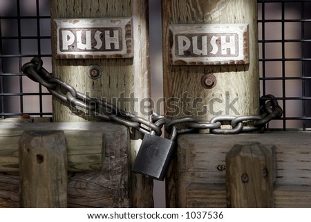 Mixed Message 2 - Chained and padlocked doors with signs instructing to Push.