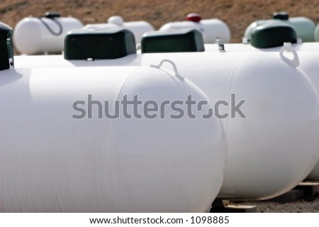 A group of Propane tanks at a Propane business located in rural America (focus point on foreground tank, shallow focus).