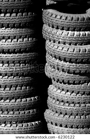 Stacks of used tires piled outside - can also represent environmental issues, industrial waste, recycling, texture, etc.