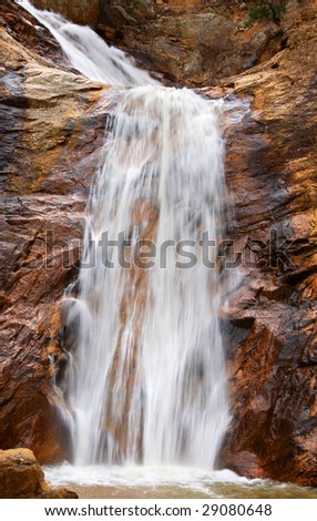 Tranquil image of the beautiful Bridal Veil Falls waterfall at Seven Falls in Colorado Springs, Colorado (slow shutter speed effect).