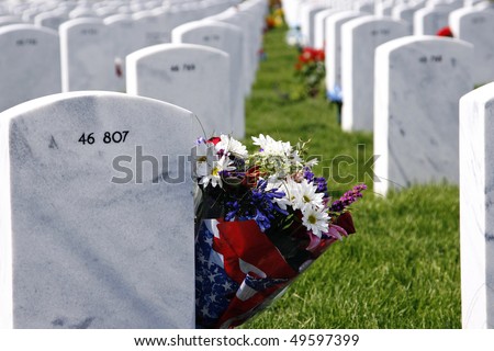 Flowers memorialize the grave of a fallen soldier at the Fort Logan National Cemetery in Colorado, USA (shallow depth of field).