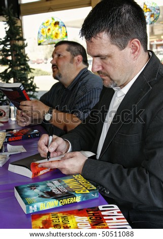 PARKER, CO - APRIL 3: Former NFL kicker turned author, Jason Elam, and co-author Steve Yohn sign their three fiction thrillers for fans at Crosswalk Christian Bookstore on April 3, 2010 in Parker, CO.