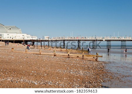 WORTHING, ENGLAND - MARCH 17. People on Worthing pier and beach, West Sussex, England on March 17, 2014
