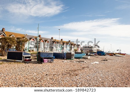WORTHING, ENGLAND - APRIL 23. Fishing boats and huts on the beach, in Worthing, West Sussex, South England on April 23, 2014