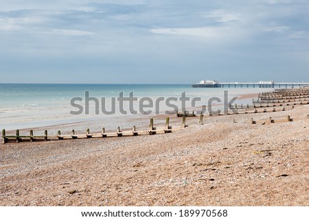 Worthing beach and pier in a cloudy day, low tide.  South coast, West Sussex, England.