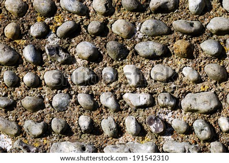 Typical English garden wall background, made of pebbles and concrete