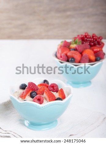 Oats porridge with berries on the white table