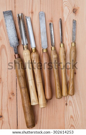 Old used wood lathe chisels selection on the wooden table, selective focus