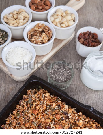 Grain free gluten free paleo granola: mixed nuts, seeds, raisins, coconut flakes, chia and coconut oil, selective focus
