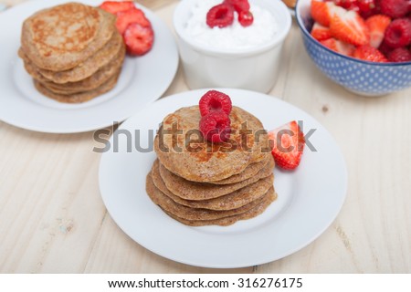 Breakfast: paleo style grain free banana almond pancakes, coconut yogurt with berries, selective focus