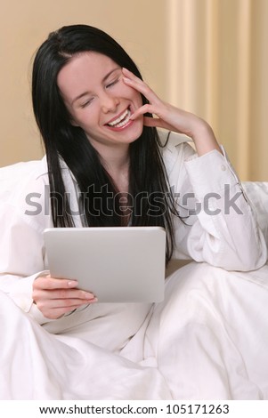 Woman Using New Technology to Read While in Bed