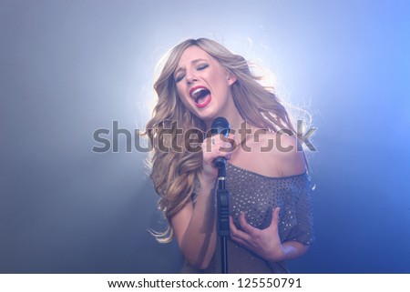 Blonde Rock Star on Stage Singing and Performing