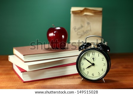 Clock Apple and Stack of Books on A Desk for Back to School