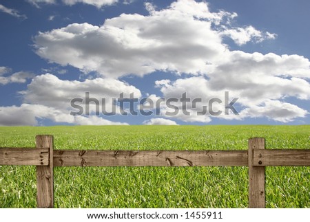 Bright Sky With Grass and Wood Fence