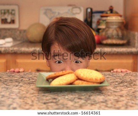 Young Asian Boy Looking at Cookies He Wants to Eat
