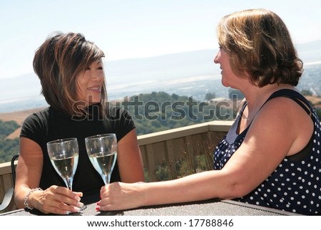 2 Women Friends Gossiping and Laughing Outdoors