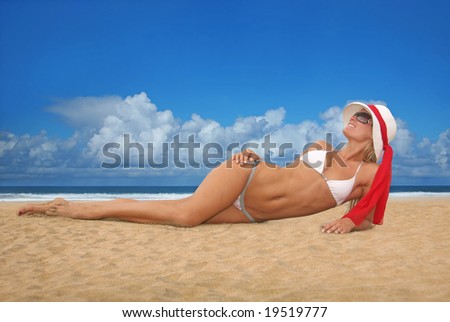 Happy Beautiful Woman Lying on the Beach in Hat and Bikini