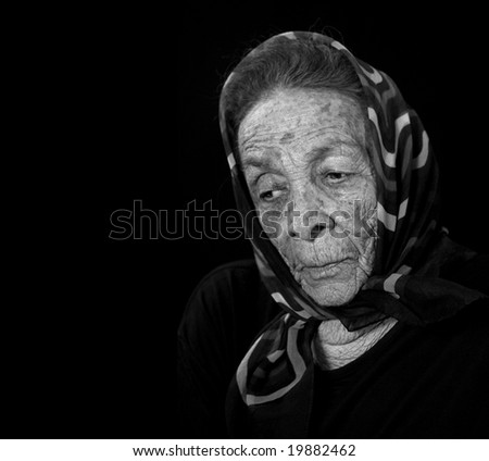Depressed Thoughtful Elderly Woman on Black
