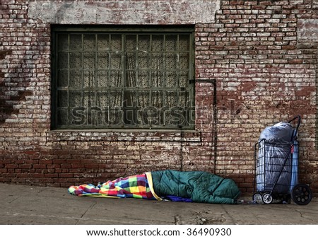 Homeless Soul Sleeping on the Streets in a Sleeping Bag Outdoors