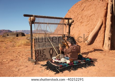 Image of a young Native American girl using a loom to weave a blanket. She is looking away from the camera and full length viewable. Horizontally framed shot.