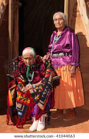 Elderly 99 year Old Navajo Woman and Her Daughter Outside a Traditional Hogan
