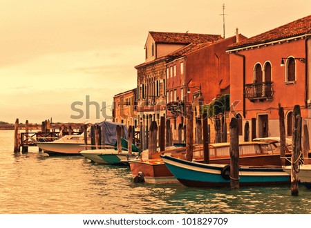Boats in front of buildings on Murano island in Venetian Lagoon during the sunset, Venice, Italy
