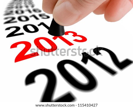 Hand with the game piece taking the next step to the new year 2013