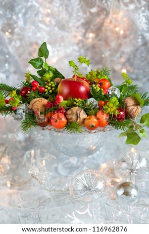 Christmas table decoration with fruit, nuts, fir branches