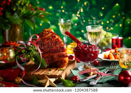 Glazed roast ham with cloves,sparkling wine and traditional vegetables dishes for Christmas dinner.