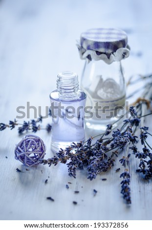 Lavender oil and bunch of dried lavender flower. Toned