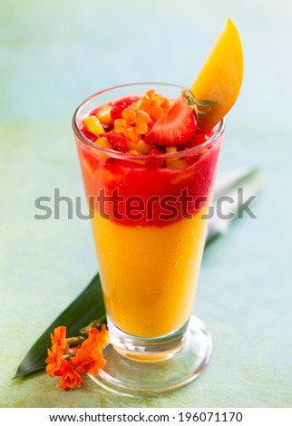 Glass of fresh mango and strawberry smoothie