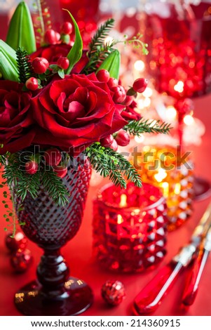 Christmas table decoration with flowers and candles