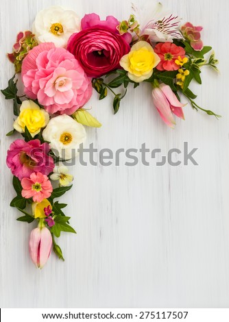 Flowers frame on white wooden background. Top view with copy space