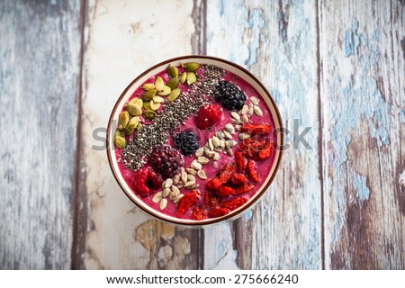 Breakfast berry smoothie bowl topped with goji berries,raspberry, blackberry, pumpkin, sunflower and chia seeds.