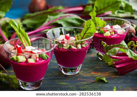 Beetroot gazpacho soup with cucumber and radish in  glasses. selective focus,tilt shift effect