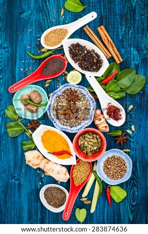 Various asian spices and herbs on a blue wooden background.Top view