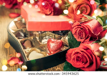 Heart shaped box of chocolate truffles with red roses