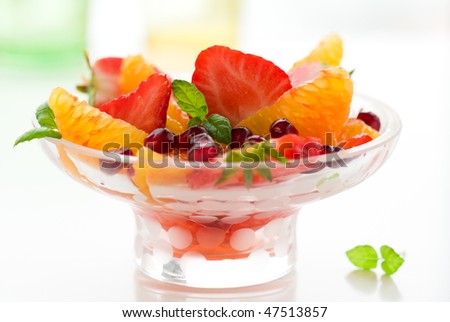 Dessert of strawberry ,orange, pomegranate seeds and mint