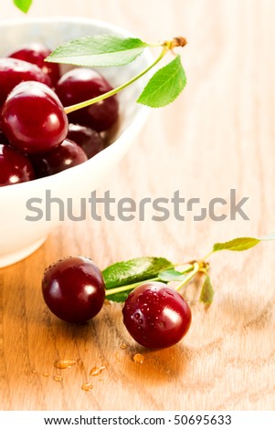 fresh red cherries  on the wood table