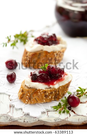Sweet cranberry jam on toast with soft cheese