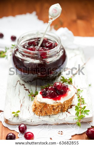 Sweet cranberry jam on toast with soft cheese