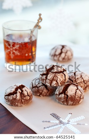 Chocolate biscuits with icing sugar and tea