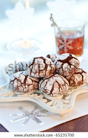 Chocolate biscuits with icing sugar and tea