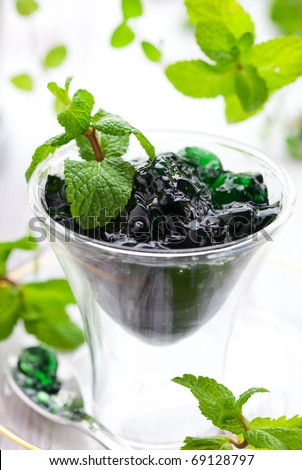 Mint jelly in glass with spoon and fresh mint leaves
