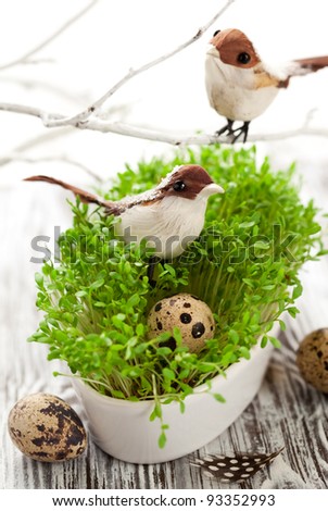 Easter decoration: birds and eggs on the fresh cress