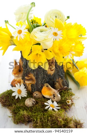 Easter decoration with spring flowers,bird and eggs on moss