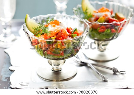 Shrimp, avocado, salmon and caviar cocktail  salad in a glass