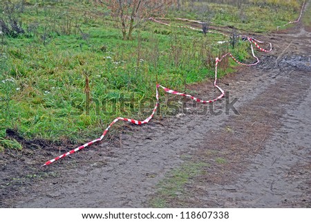long red stripped line on the grunge ground road, security details
