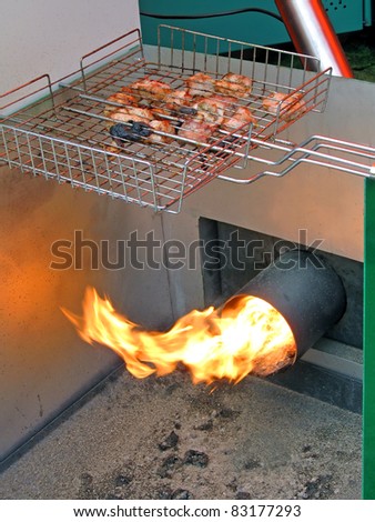 roasted meat, food preparation with fire. modern kitchen details.