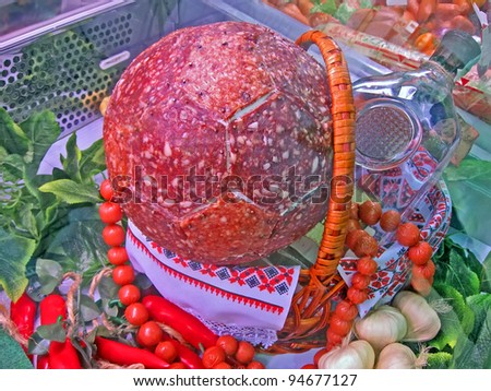 fresh sausage sport balls and glass bottle with vodka in basket, ukrainian national food details